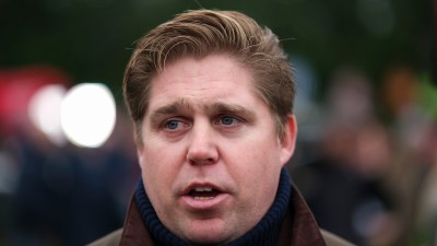 GettyImages 2191466987 depicts a business meeting with diverse professionals discussing strategies around a conference table.