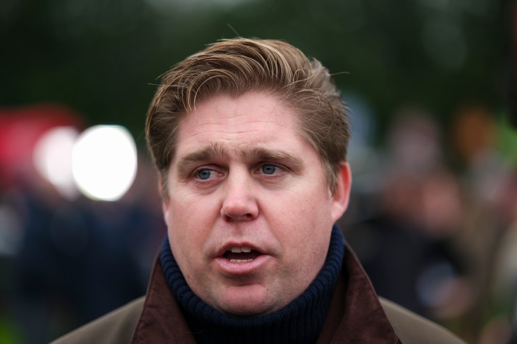 GettyImages 2191466987 depicts a business meeting with diverse professionals discussing strategies around a conference table.
