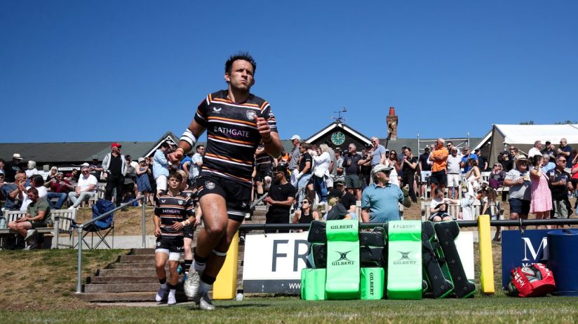 GettyImages 2215412924 shows a bustling cityscape with modern skyscrapers under a clear blue sky, highlighting urban devel...