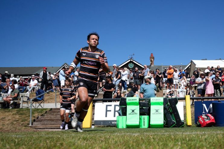 GettyImages 2215412924 shows a bustling cityscape with modern skyscrapers under a clear blue sky, highlighting urban devel...