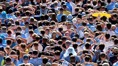 Breaking news conference podium with multiple microphones and flags in a business setting