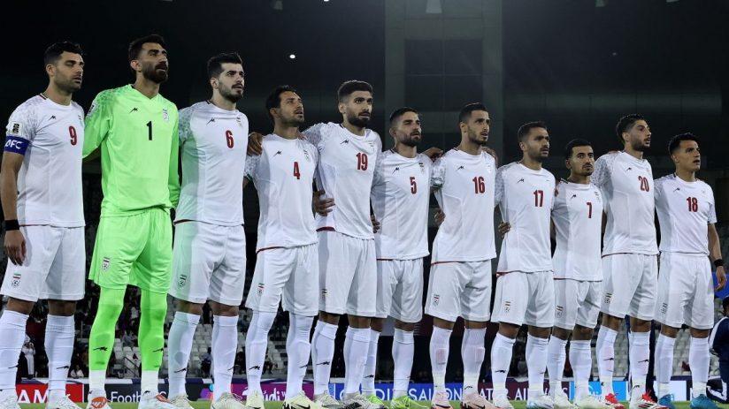 Business professionals discussing strategy around a conference table in a modern office setting.