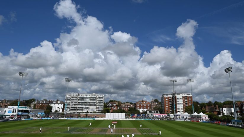 GettyImages 2234482077: Business professionals engaging in a meeting, discussing strategies, using laptops and documents i...
