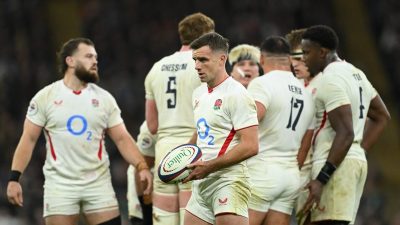 Getty Images logo on a smartphone screen against a backdrop of digital stock photos, symbolizing media and photography ind...