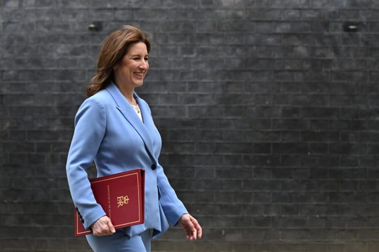 GettyImages 2264549868 featuring a prominent business executive at a corporate conference, engaged in a panel discussion.