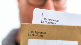 HM Revenue and Customs building exterior with official signage and British flag on a clear day