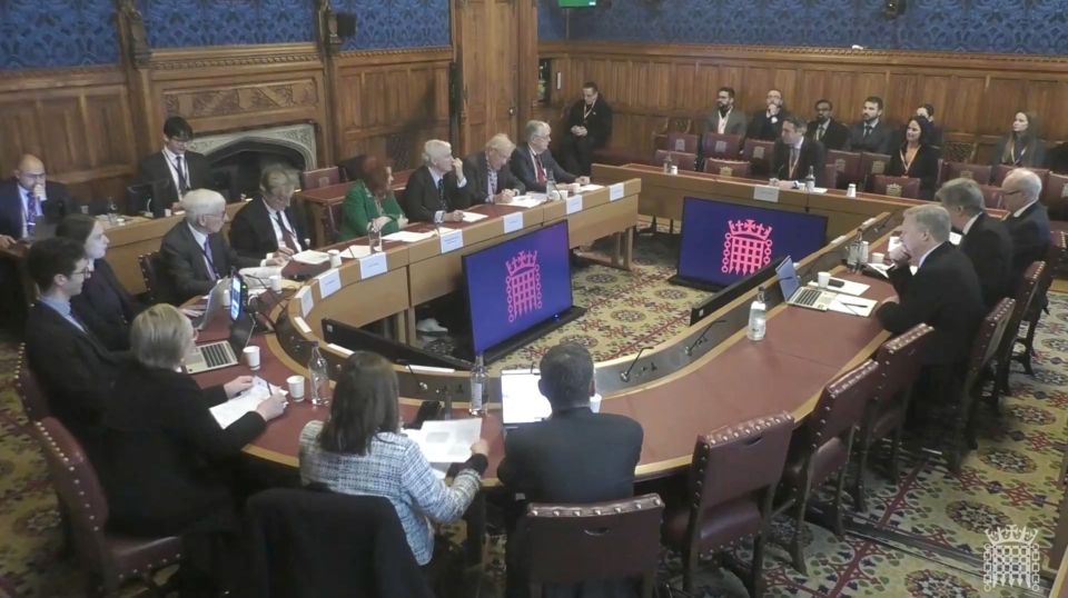 House of Lords exterior with historic architecture under clear blue skies, representing British political heritage