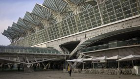Lisbon train station bustling with commuters, showcasing modern architecture and vibrant city atmosphere during rush hour