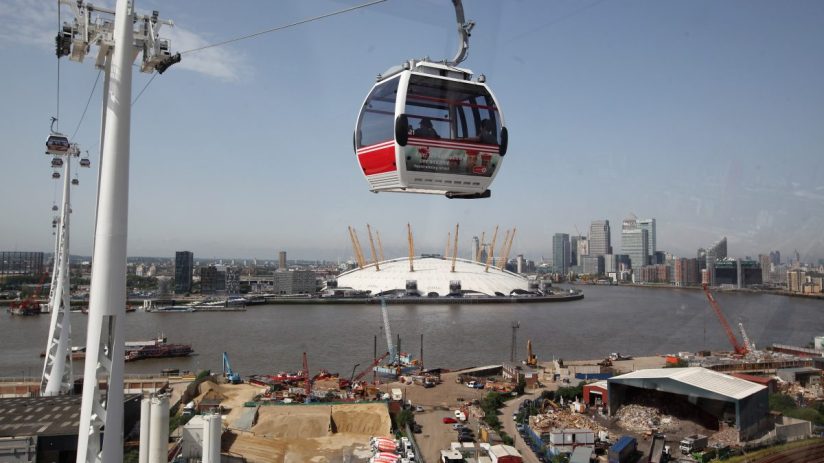 Greenwich London cable car over River Thames with city skyline, highlighting urban transport and scenic views