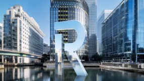 Modern London office building with reflective glass windows under a clear sky, showcasing urban architecture and business ...