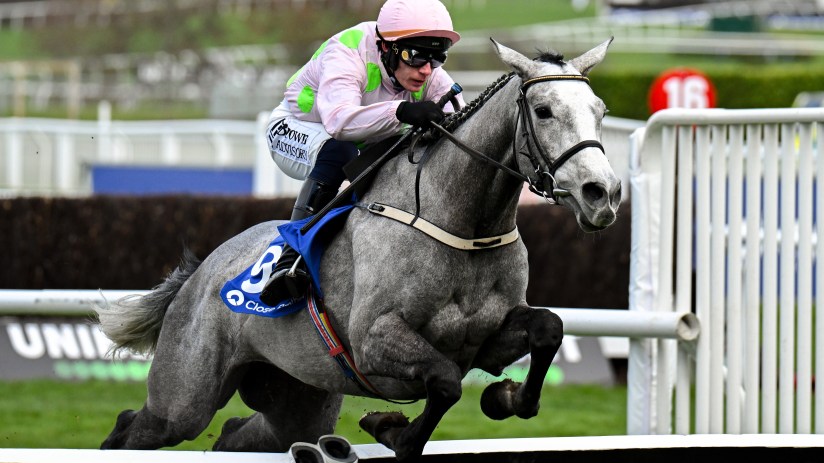 Lossiemouth coastal scene highlighting scenic beach, sea waves, and nearby landscape under a clear blue sky.