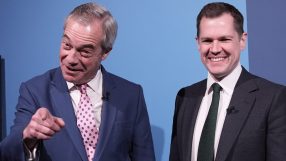 Nigel Farage and Robert Jenrick engaged in discussion at a public event, both in formal attire, highlighting political dis...