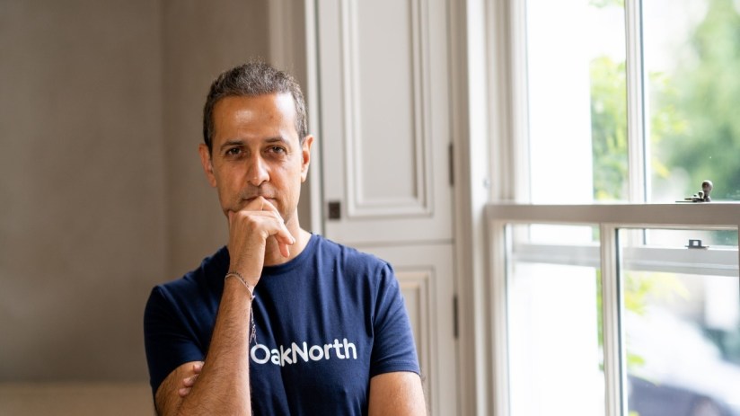 Person reviewing financial charts on a digital tablet, highlighting market trends and economic data for business analysis