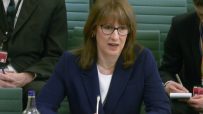 Rachel Reeves speaking at Treasury Committee meeting, highlighting key points on financial policies, dressed in business a...