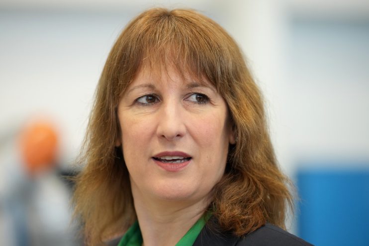 Rachel Reeves delivering a speech at a press conference, addressing economic policies and financial strategies.