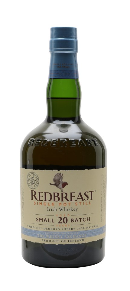 Redbreast 20 Year Old Oloroso Casks whiskey bottle with rich amber hue against a wooden background