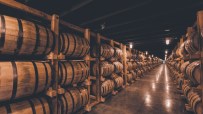 Single barrel rickhouse showcasing neatly arranged wooden barrels in a spacious storage facility for aging spirits.