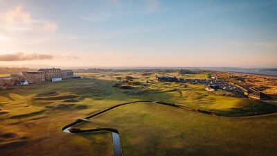 St Andrews Old Course scenic view showcasing historic links, lush fairways, and iconic Swilcan Bridge under clear skies