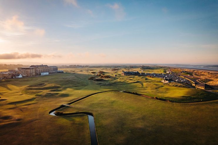 St Andrews Old Course scenic view showcasing historic links, lush fairways, and iconic Swilcan Bridge under clear skies