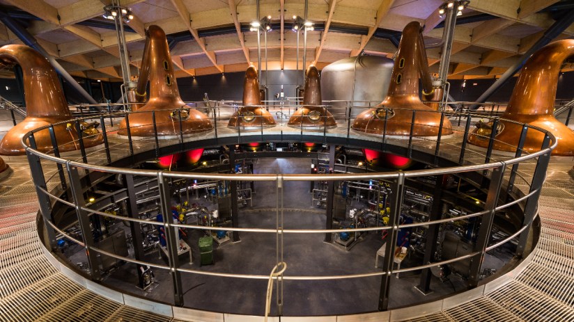 The Macallan Distillery in scenic Scottish landscape, showcasing its architecture and surrounding natural beauty.