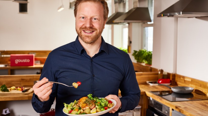 Timo Boltd, founder of Gousto, poses confidently against a modern office backdrop, showcasing his entrepreneurial spirit.