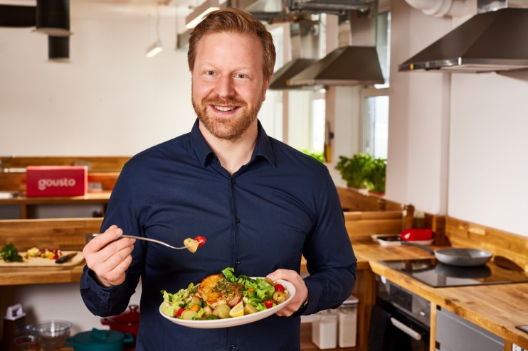 Timo Boltd, founder of Gousto, poses confidently against a modern office backdrop, showcasing his entrepreneurial spirit.