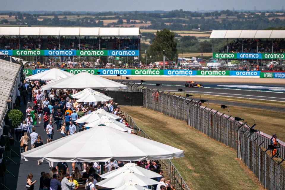 Trackside terrace offering a scenic view at a bustling racecourse, highlighting vibrant atmosphere and spectator excitement.
