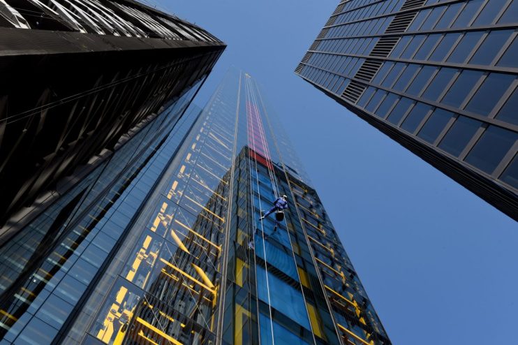Skyline of City of London with iconic financial district buildings, highlighting UK investments and economic growth.