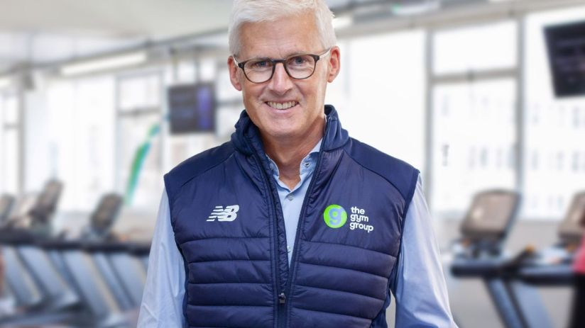 Business meeting with diverse team discussing strategy at a modern office, featuring charts and laptops on the table