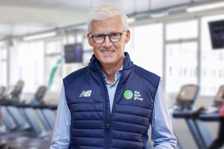 Business meeting with diverse team discussing strategy at a modern office, featuring charts and laptops on the table