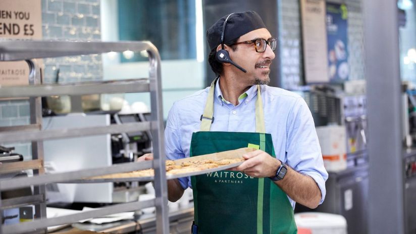 Business professionals discussing strategy in a modern office setting with digital devices and charts on the table