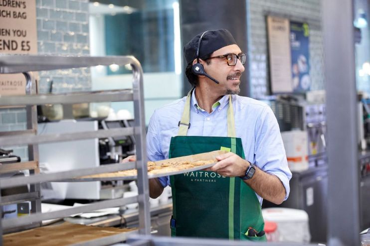 Business professionals discussing strategy in a modern office setting with digital devices and charts on the table