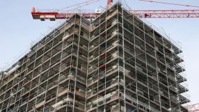 Business meeting with diverse professionals discussing strategy around a conference table in a modern office setting