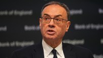 Andrew Bailey addressing economic policies at a press conference, emphasizing financial stability amidst market challenges