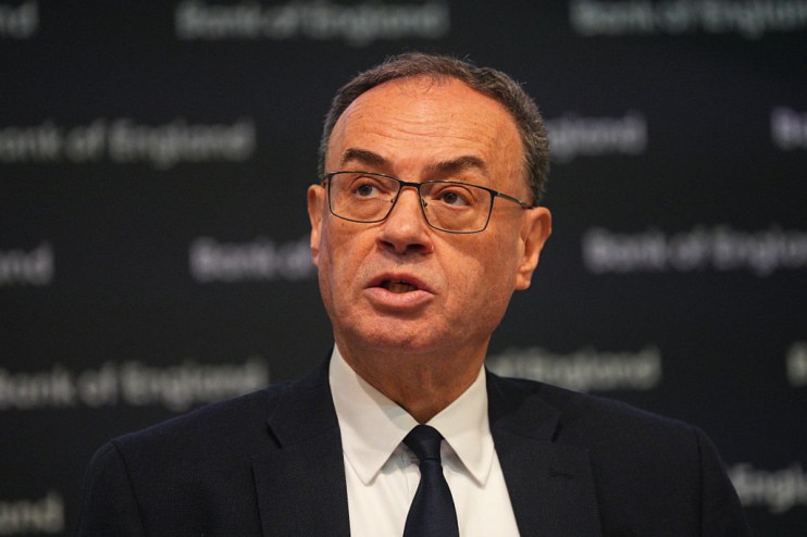 Andrew Bailey addressing economic policies at a press conference, emphasizing financial stability amidst market challenges