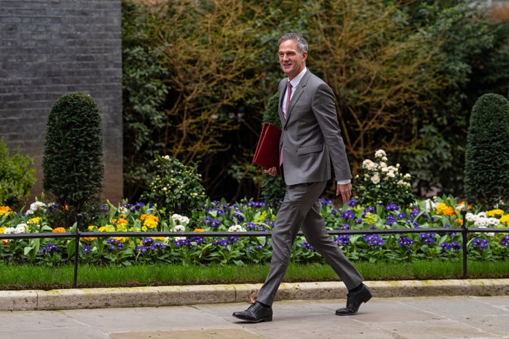 Business Secretary Peter Kyle speaking at a podium during a press conference on economic policy reforms