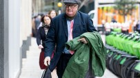 Crispin Odey entering court in a formal suit, capturing a pivotal moment in a high-profile legal proceeding.
