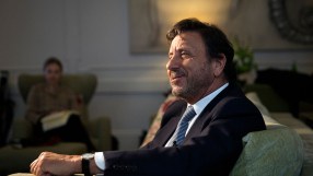 Sir Rocco Forte standing confidently in a luxury hotel lobby, showcasing elegance and hospitality leadership