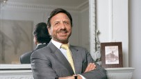 Rocco Forte, renowned hotelier, standing confidently in a luxury hotel lobby, showcasing elegance and hospitality expertise