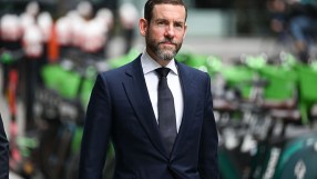 Lex Greensill speaking at a business conference, wearing a suit and tie, gesturing with his hand while discussing financia...