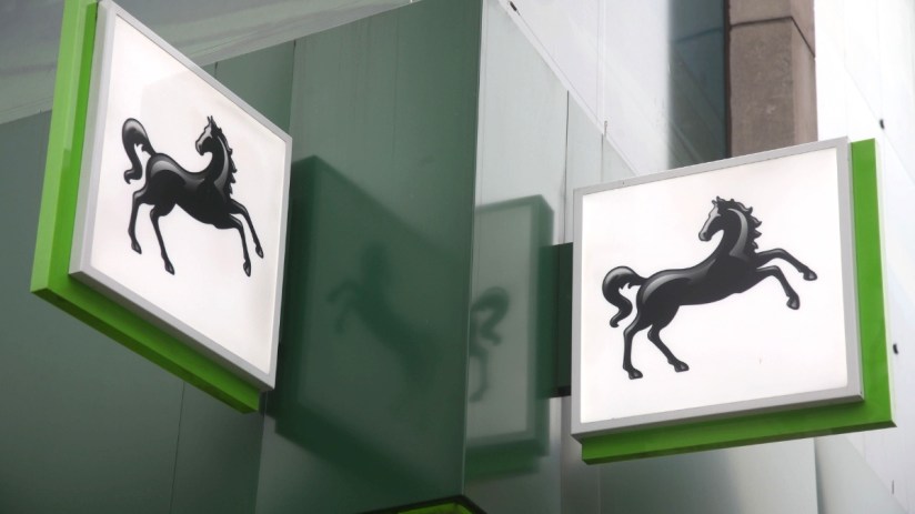 Lloyds headquarters exterior against a clear sky, showcasing iconic modern architecture in a bustling business district