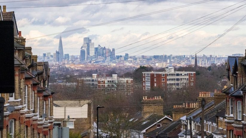 City skyline captured by Nick the photographer, showcasing modern architecture and tall buildings against a clear sky.