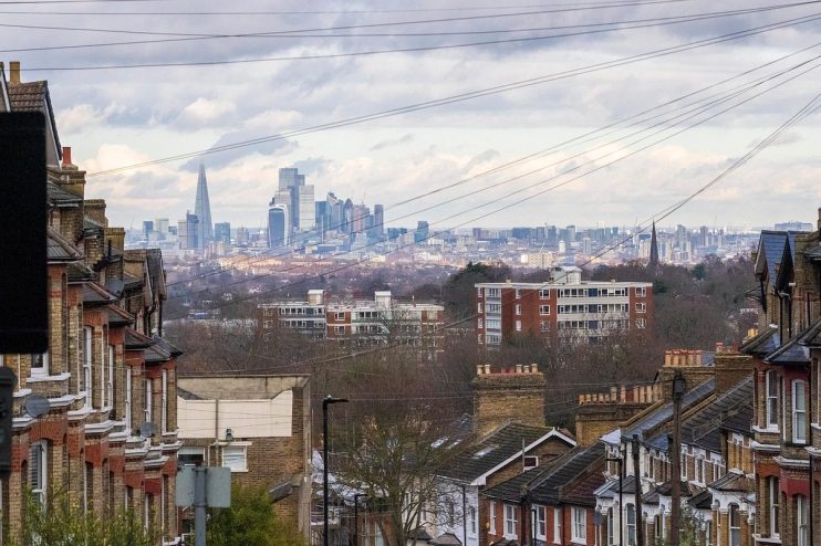 City skyline captured by Nick the photographer, showcasing modern architecture and tall buildings against a clear sky.