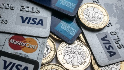 Debit cards and coins representing financial transactions and payments in a business context.