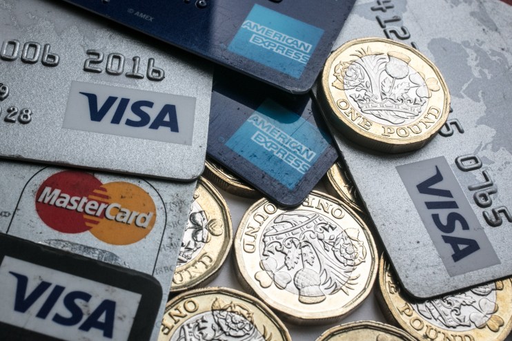 Debit cards and coins representing financial transactions and payments in a business context.