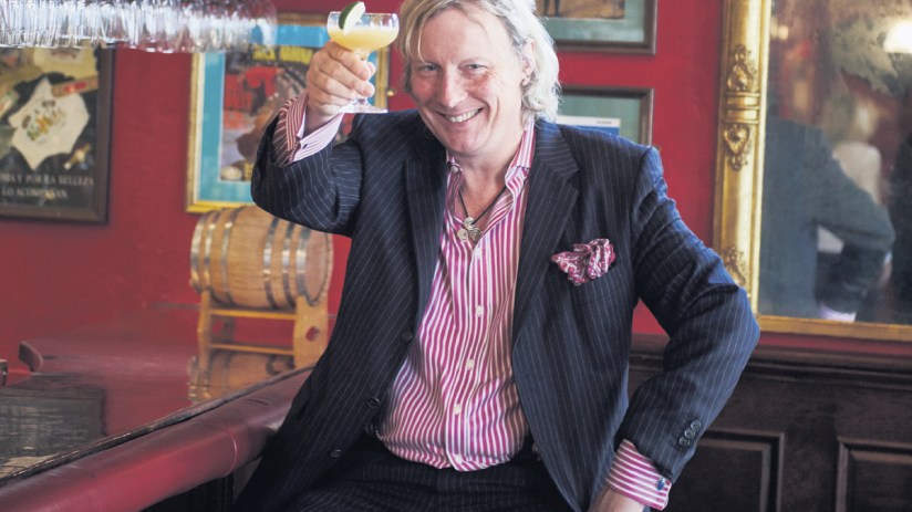 Ranald presenting at a business conference, emphasizing key strategies in a suit and tie, engaging with a diverse audience