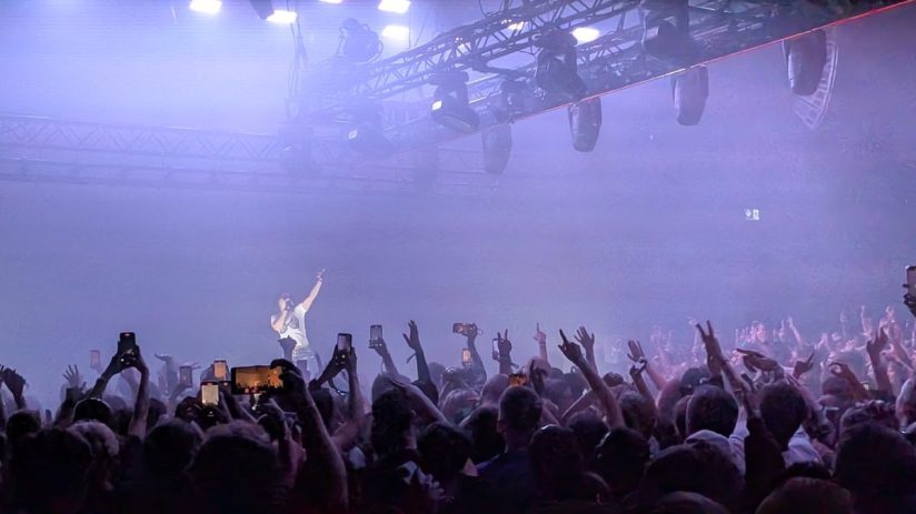 Charli XCX poses at Revolut event, showcasing collaboration in modern fashion and tech innovation.