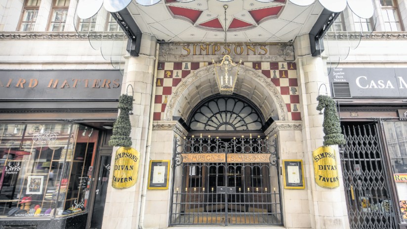 The Simpsons family gathered on their iconic couch in Springfield living room, showcasing classic animated TV characters.