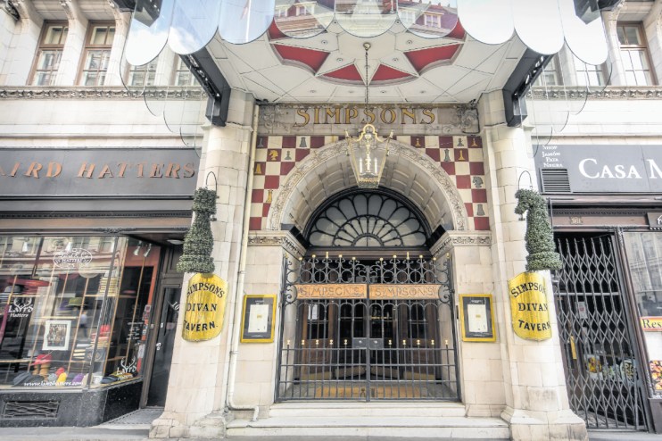 The Simpsons family gathered on their iconic couch in Springfield living room, showcasing classic animated TV characters.