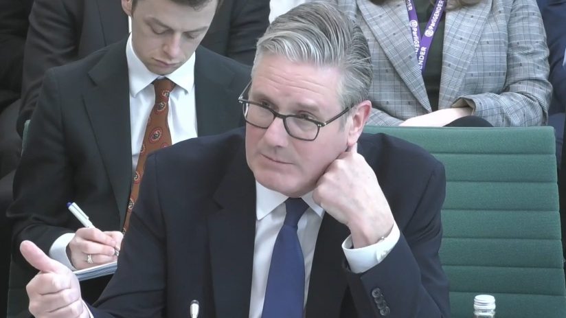 Keir Starmer addressing the Liaison Committee in a formal setting, discussing key political issues and policy matters.